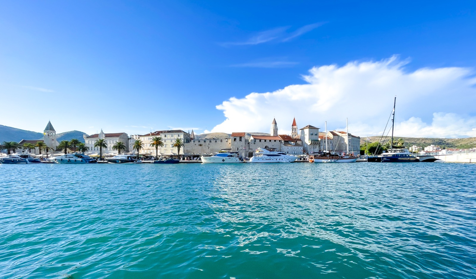 Stone rooftops of the old town of Trogir under late afternoon light